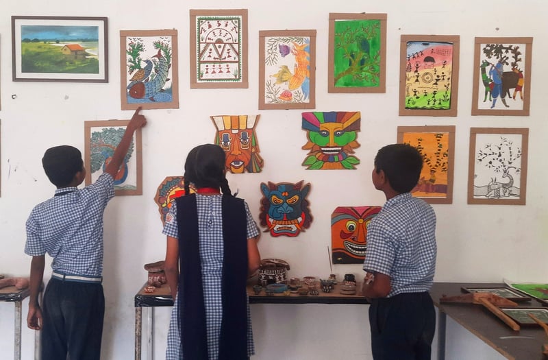 Prince Nimbare (left) and his classmates show off their art work at Mundhegaon Ashram School, Nashik.