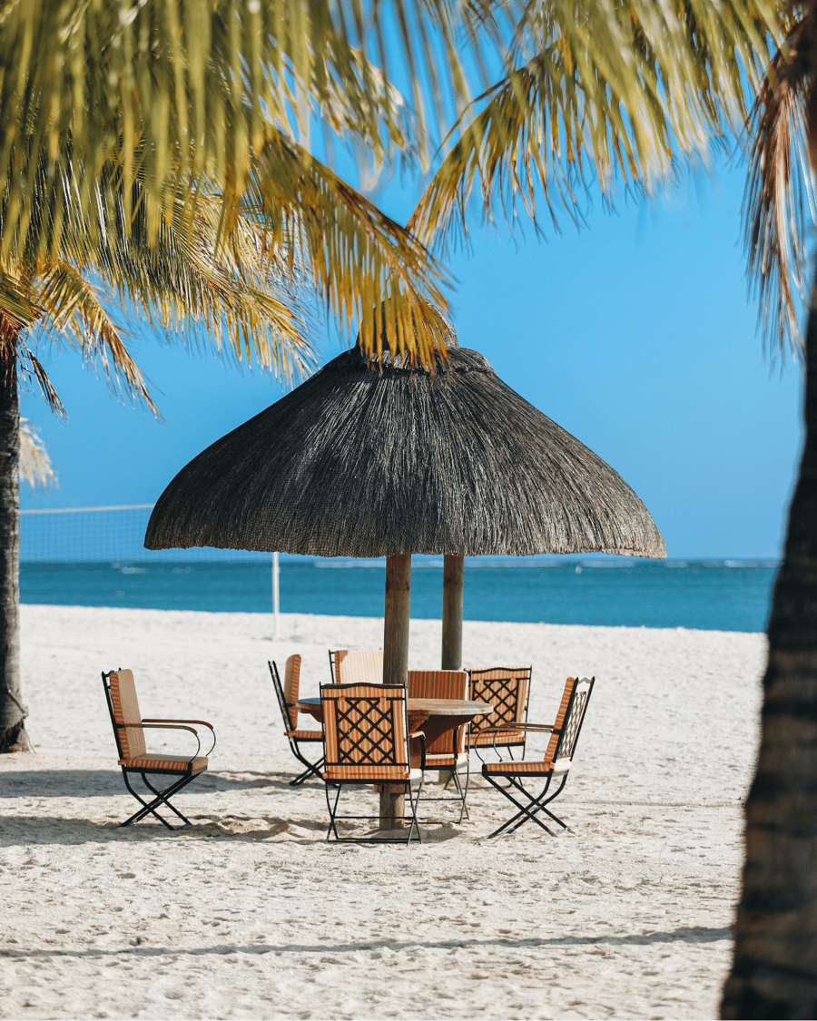 A thatched parasol on a white beach in Mauritius