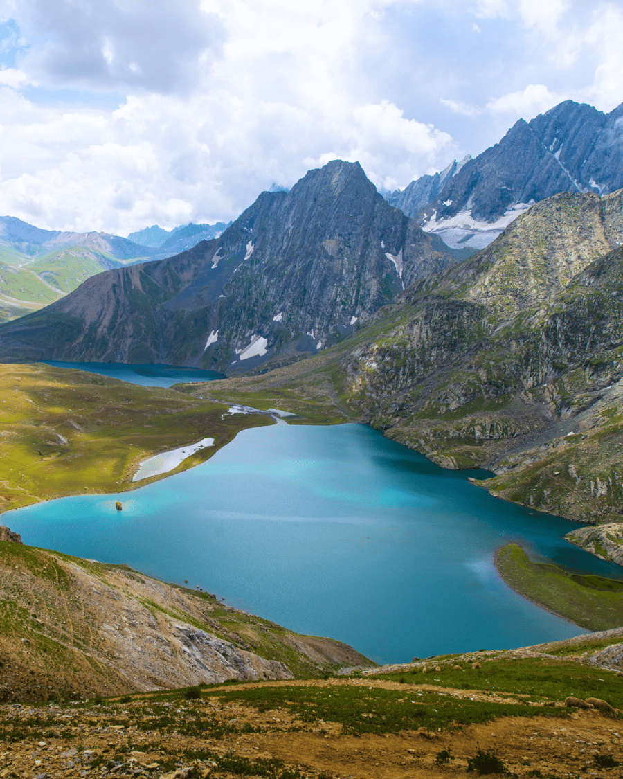 A turquoise alpine lake below the peaks of Kashmir