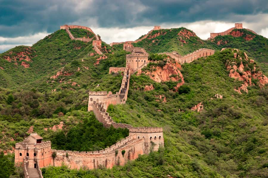 The Great Wall of China winding over green hills