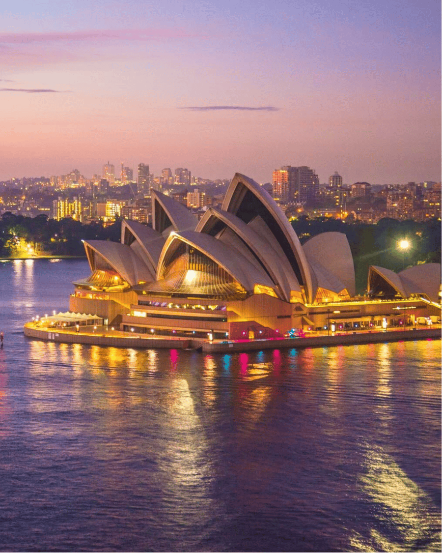 The Sydney Opera House lit up at dusk