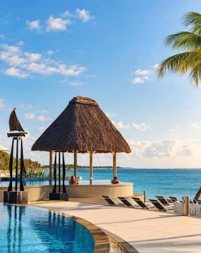 A thatched parasol on a white beach in Mauritius